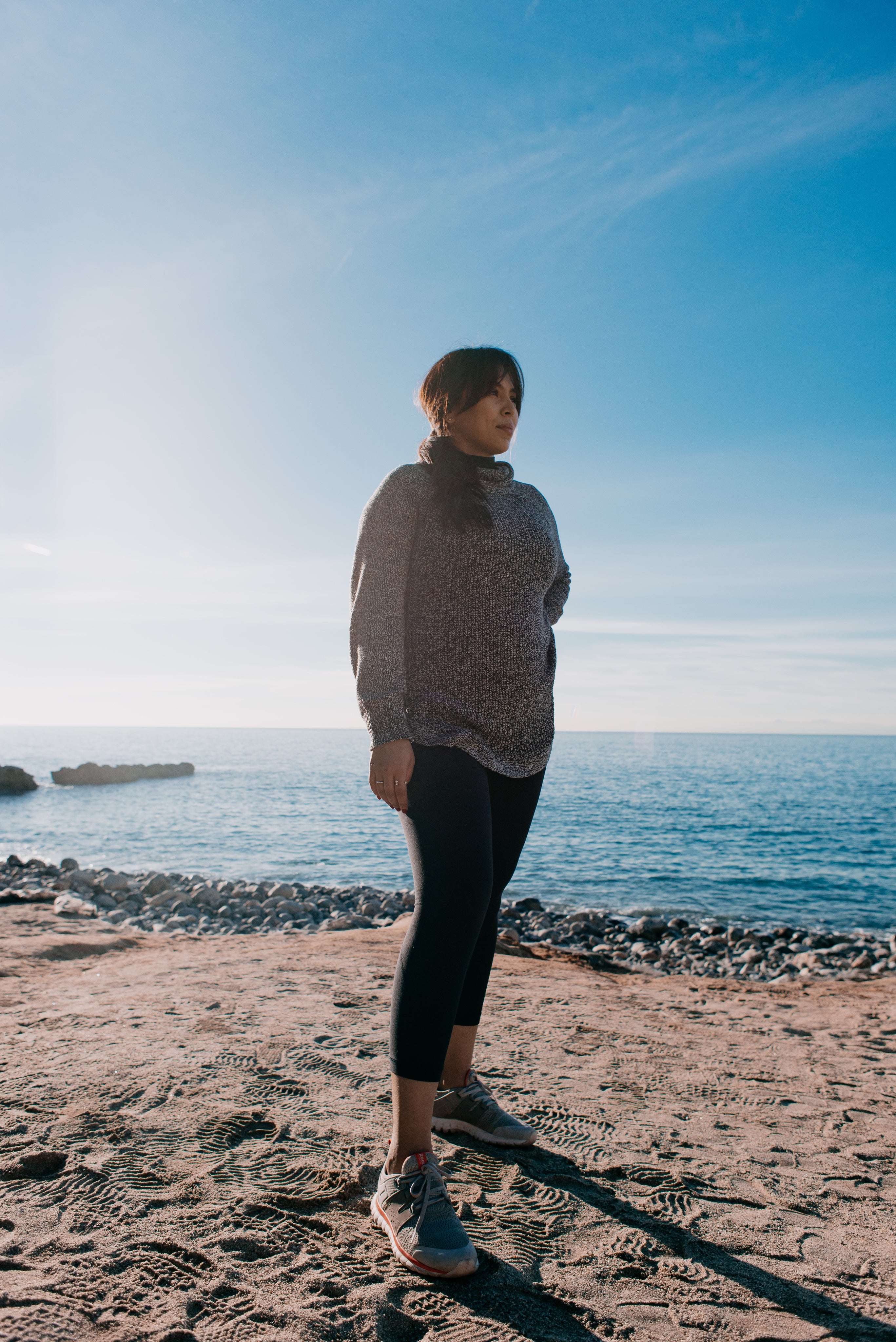 files/woman-stands-thoughtful-on-a-beach-in-the-morning-sun.jpg